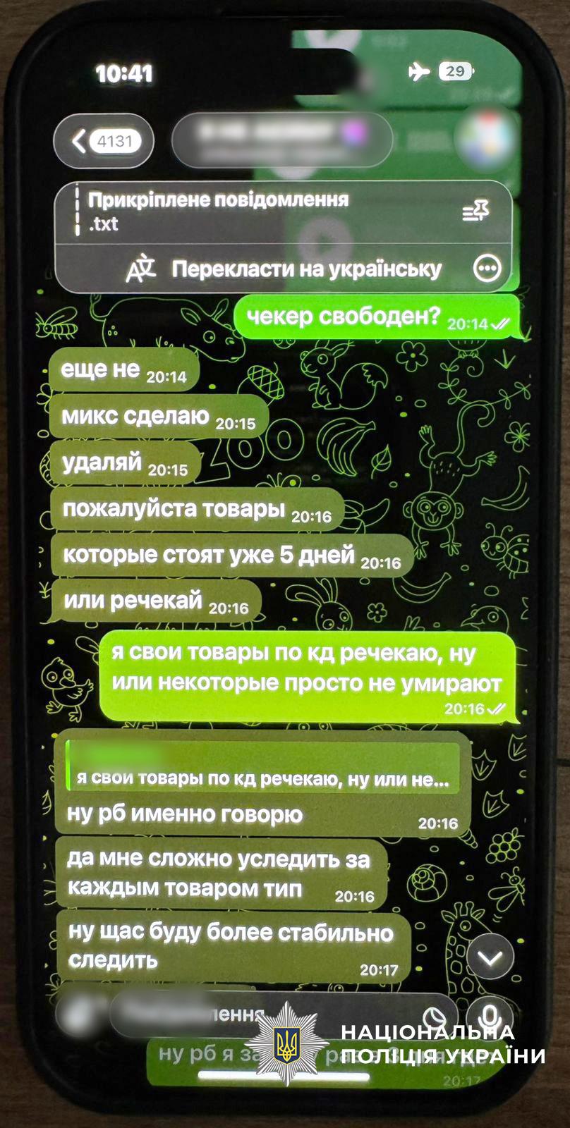На фотографії зображено екран смартфона з відкритим чатом у месенджері Telegram. У листуванні учасники використовують професійний жарлон, обговорюючи роботу техінчних інструментів, таких як чекер, та управління товарами. Текст повідомлень написаний мовою, схожою на російську.  Повідомлення відправника виділені яскраво-зеленим кольором, а відповіді співрозмовника — сірим. Шпалери чату мають темний фон із контурними малюнками тварин. У верхній частині екрана видно час 10:41 та значок режиму польоту. Деякі елементи інтерфейсу та імена користувачів розмиті для приховування особистих даних.  У нижній частині зображення по центру розміщено білий логотип Національної поліції України з відповідним написом. Світлина ілюструє фрагмент переписки, яка документується як доказ у межах слідчих дій щодо кіберзлочинів.