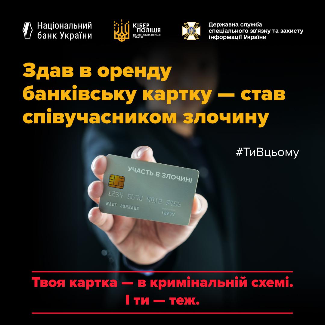 Інформаційне зображення на темному тлі, у верхній частині якого розміщено три білі логотипи з підписами: Національний банк України, Кіберполіція Національної поліції України та Державна служба спеціального зв'язку та захисту інформації України. Нижче великими жовтими літерами написано заголовок у три рядки: Здав в оренду банківську картку — став співучасником злочину. У центральній частині на розмитому тлі видно руку, яка тримає сіру банківську картку з чіпом, надрукованим номером, терміном дії та написом УЧАСТЬ В ЗЛОЧИНІ у верхній частині. Праворуч від картки розміщено білий хештег #ТиВцьому. У нижній частині між двома червоними горизонтальними лініями знаходиться напис червоними та рожевими літерами: Твоя картка — в кримінальній схемі. І ти — теж.